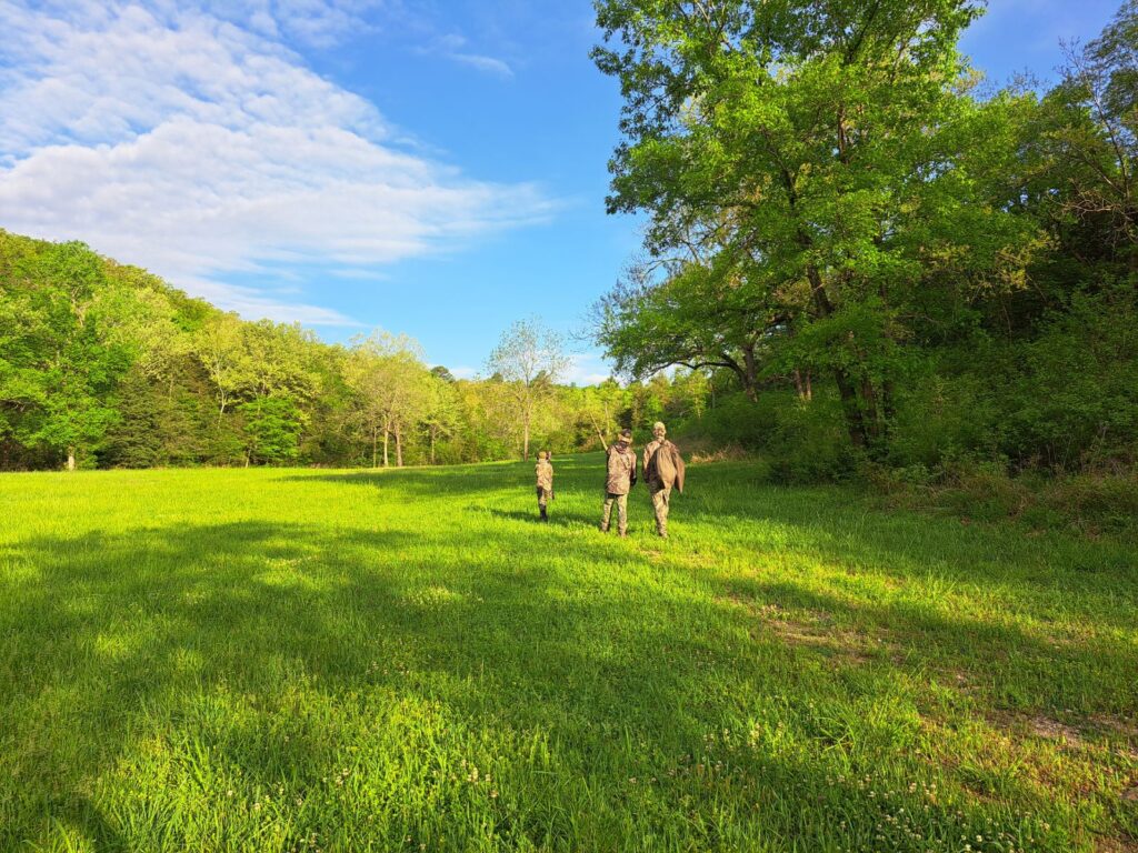 Hunters walking in a meadow